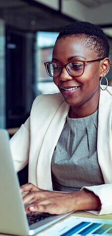 Image of a happy woman using a laptop