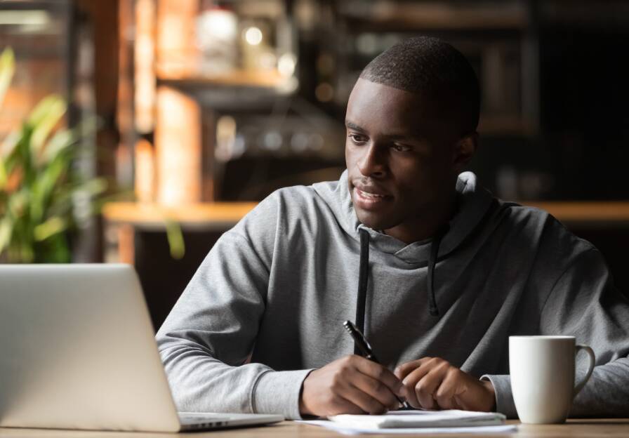 6.5._stock-photo-focused-young-black-man-working-studying-with-wireless-laptop-make-notes-in-cafe-focused-african-1492614011.jpg