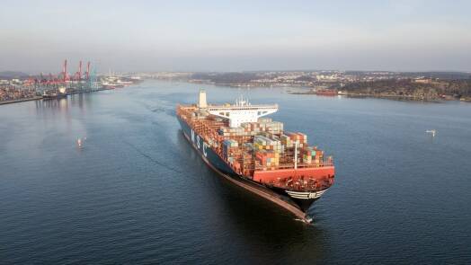 A big containership leaving the port loaded with containers