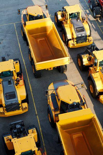 Yellow work vehicles at the port.