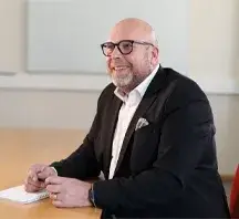 Picture of Magnus Larsson sitting at a table.