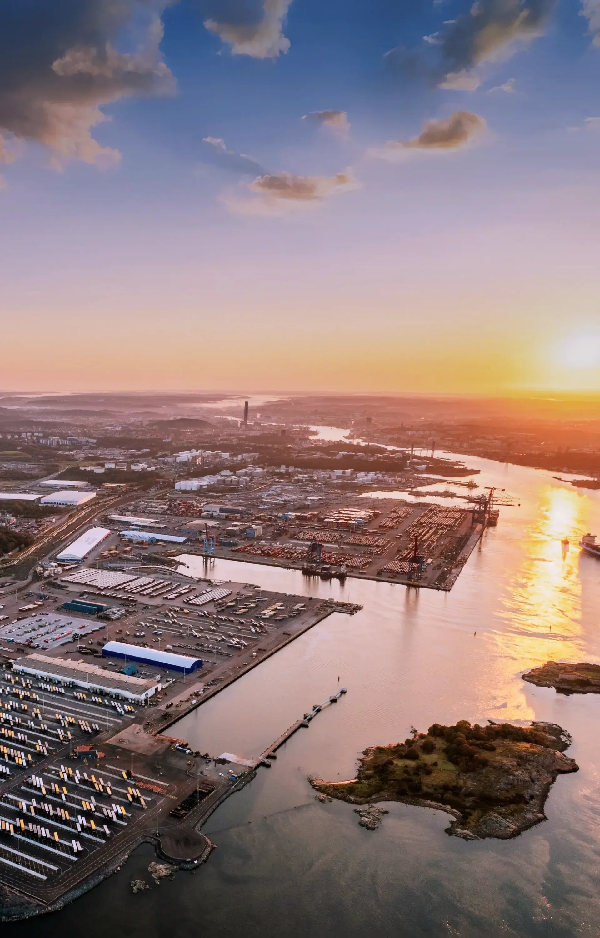 Aerial view of the Port of Gothenburg with a sunset in the background.