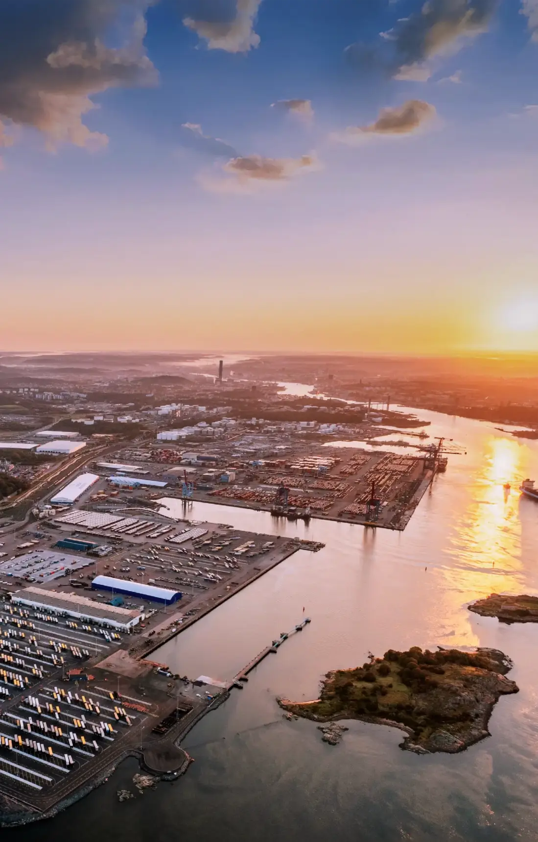 Aerial view of the Port of Gothenburg with a sunset in the background.