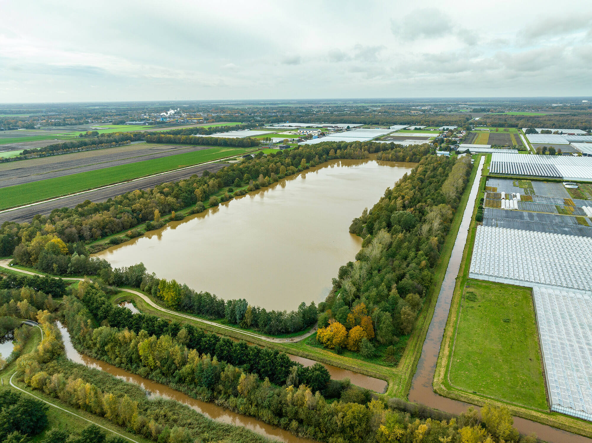 Luchtfoto van de Urkervaart, met rechts akkers en links bebouwing