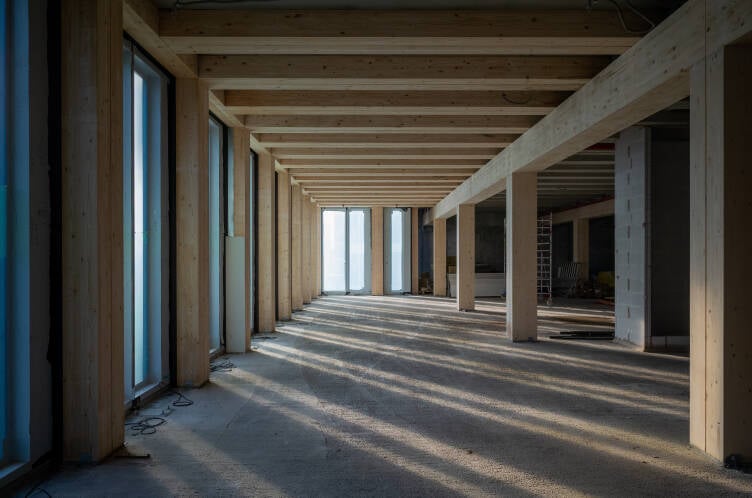 Interior of a wood framed construction site with sunlight streaming in