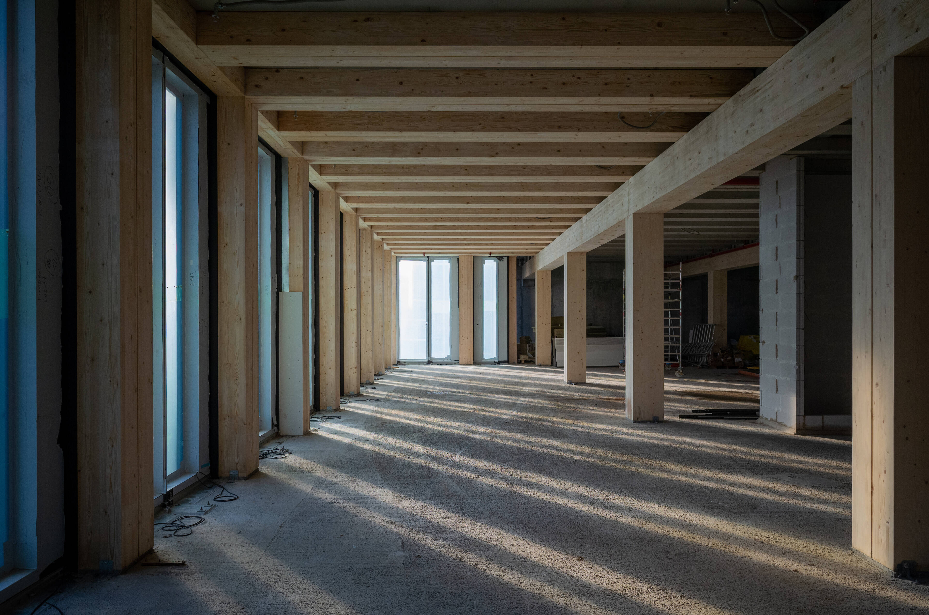 Interior of a wood framed construction site with sunlight streaming in