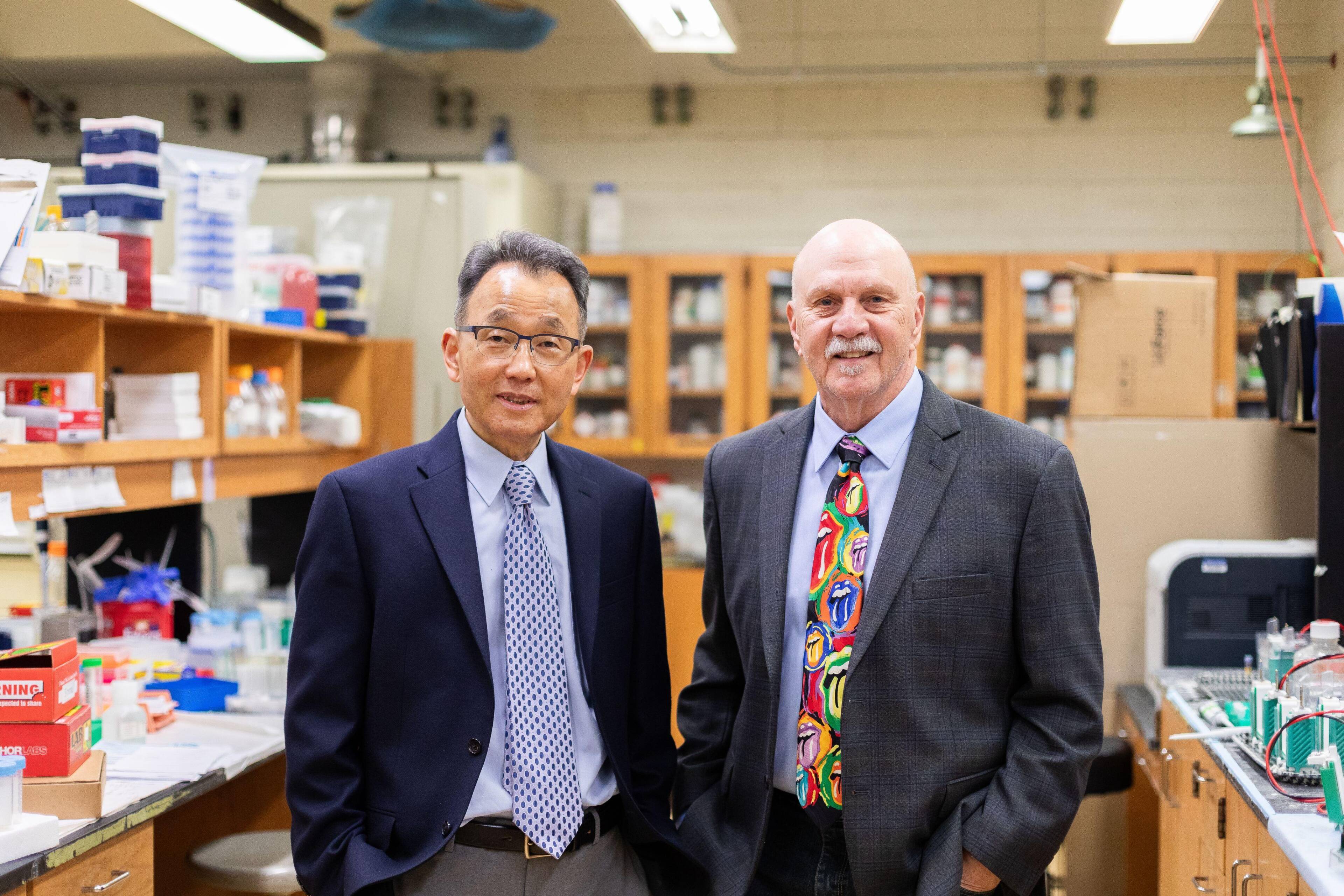 Dr. Wonhwa Cho, head of the UIC Chemistry Department at the left, and alumnus Dr. Herb Paaren at the right, pictured in a lab.