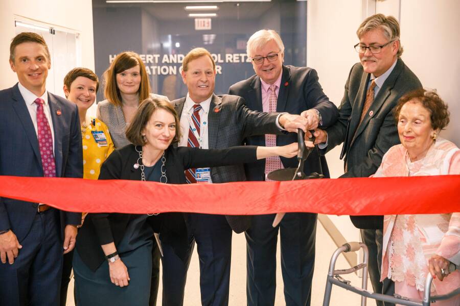 Carol Retzky, right, watches a ribbon-cutting ceremony for the Herbert and Carol Retzky Simulation Center.