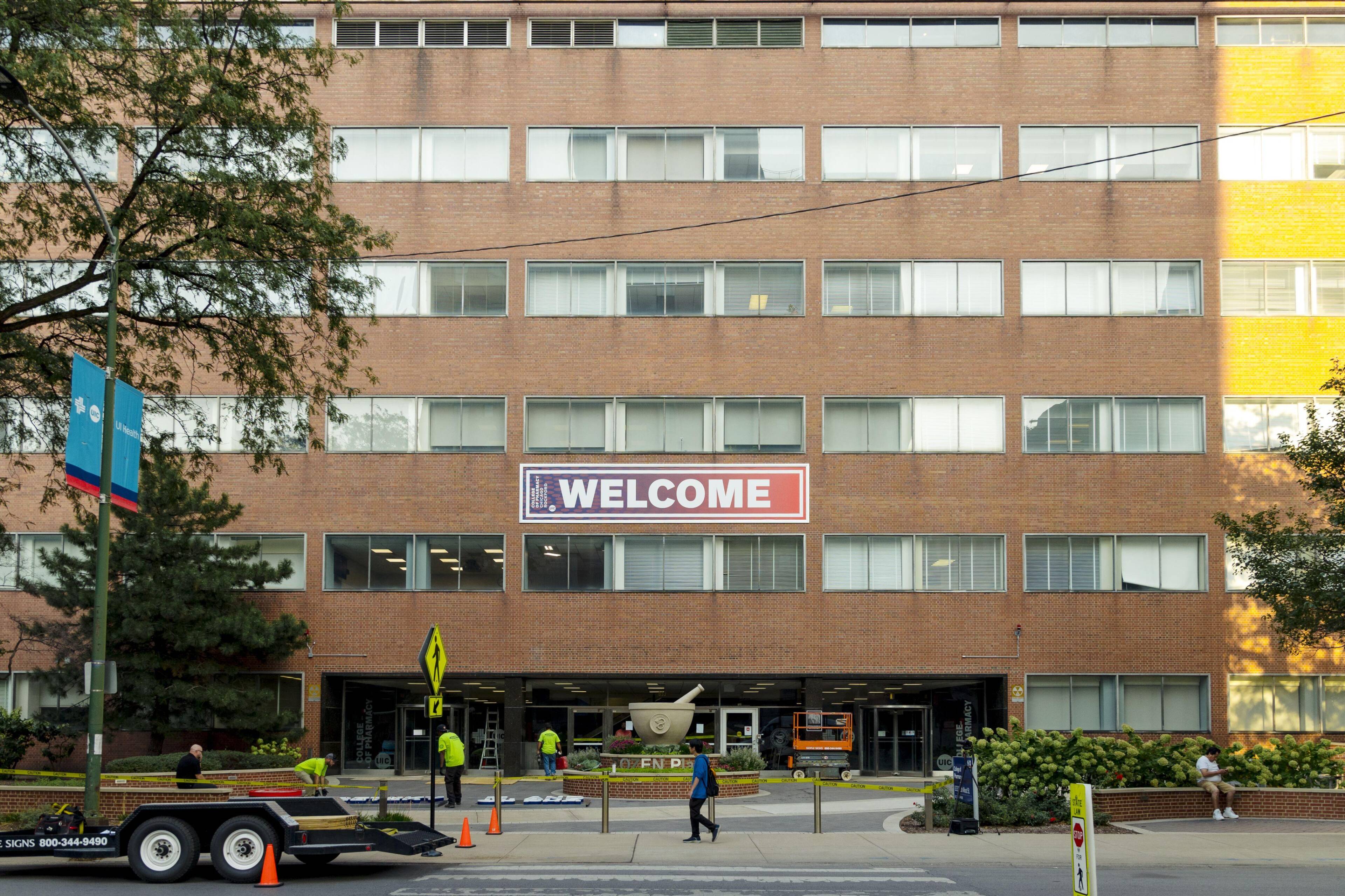 A photo of the UIC College of Pharmacy building with a welcome sign.