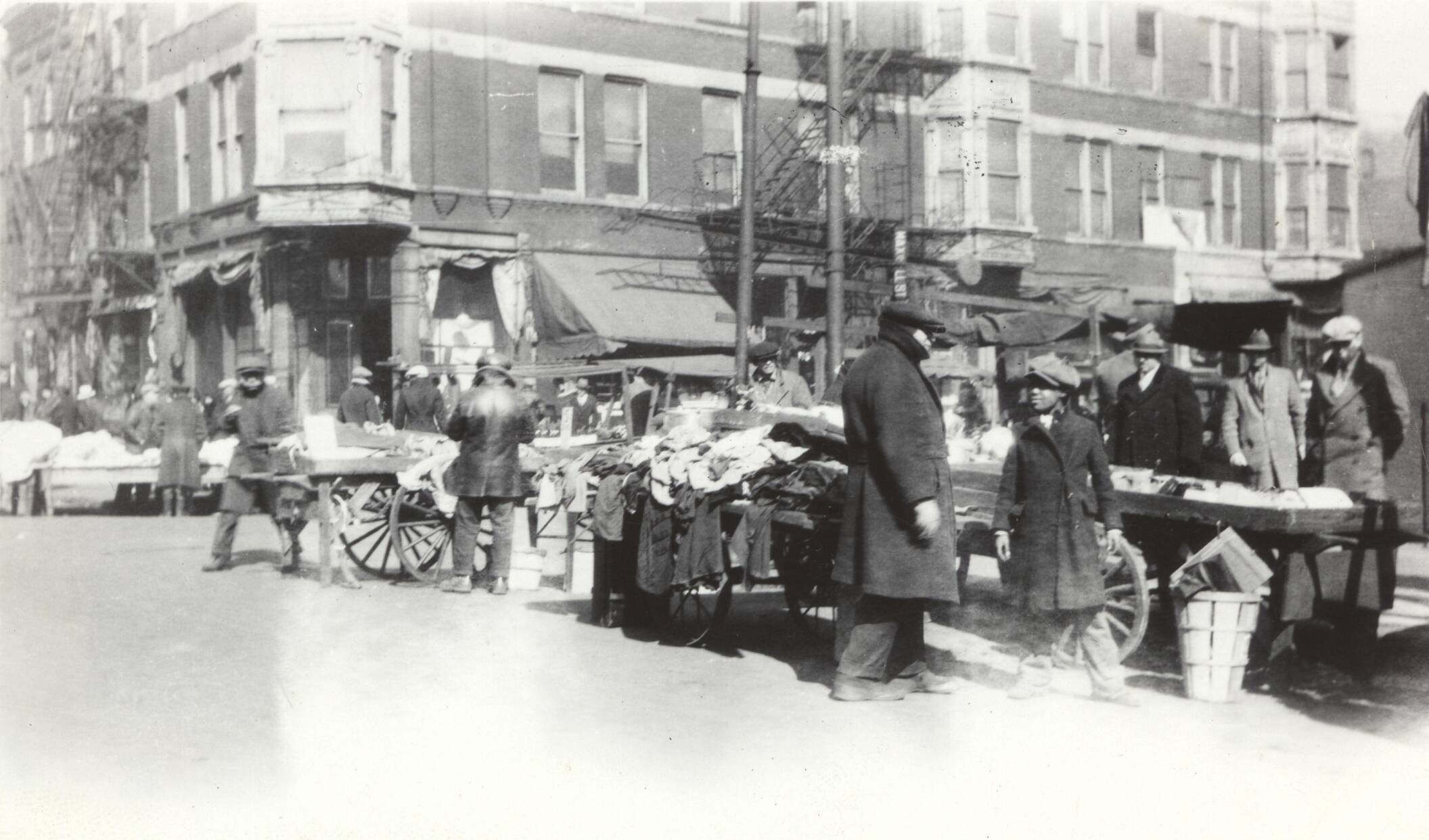 Maxwell Street market scene with goods for sale in handbarrow carts, Marcy-Newberry Association records.
