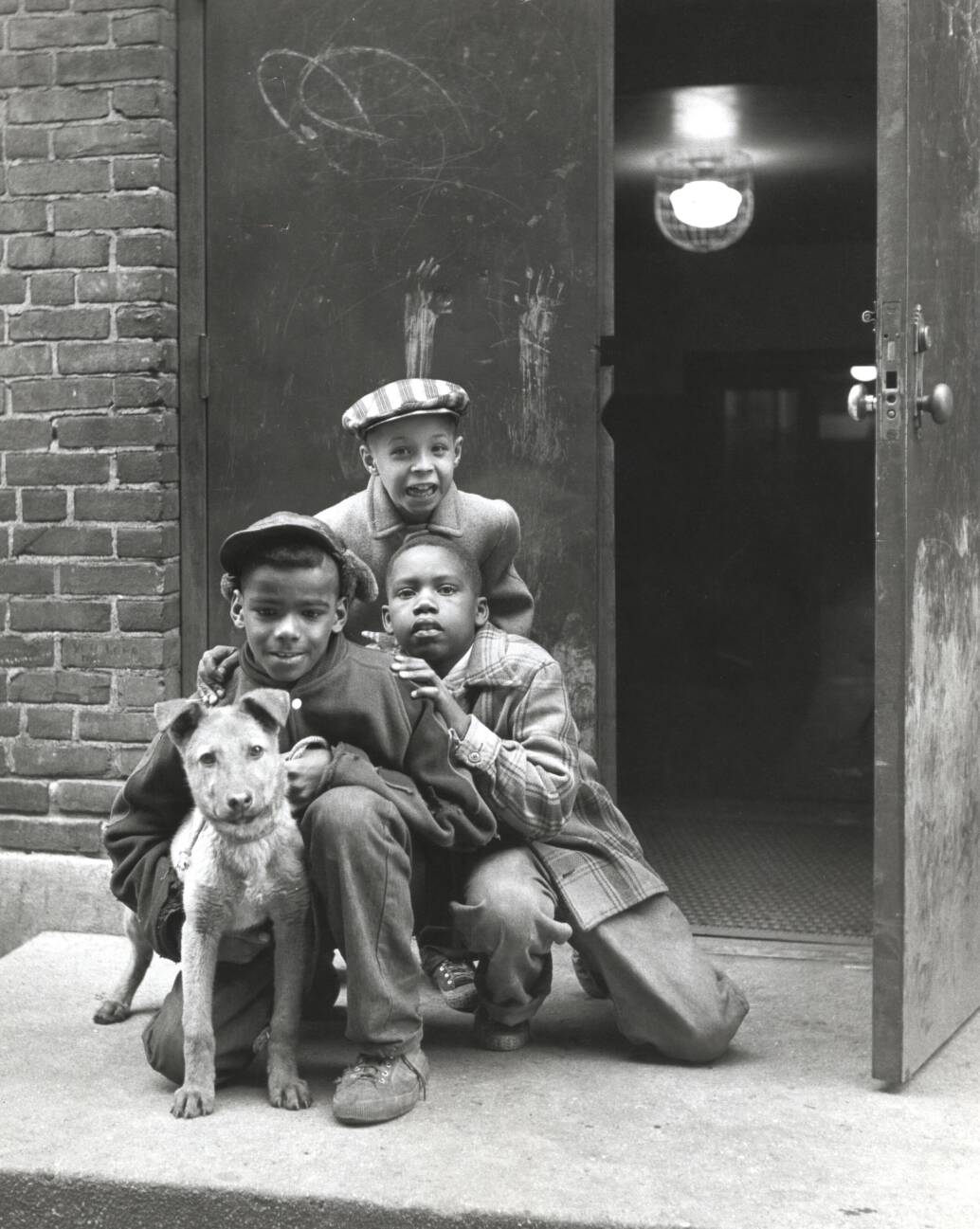 Three boys with a dog, Marcy-Newberry Association records.