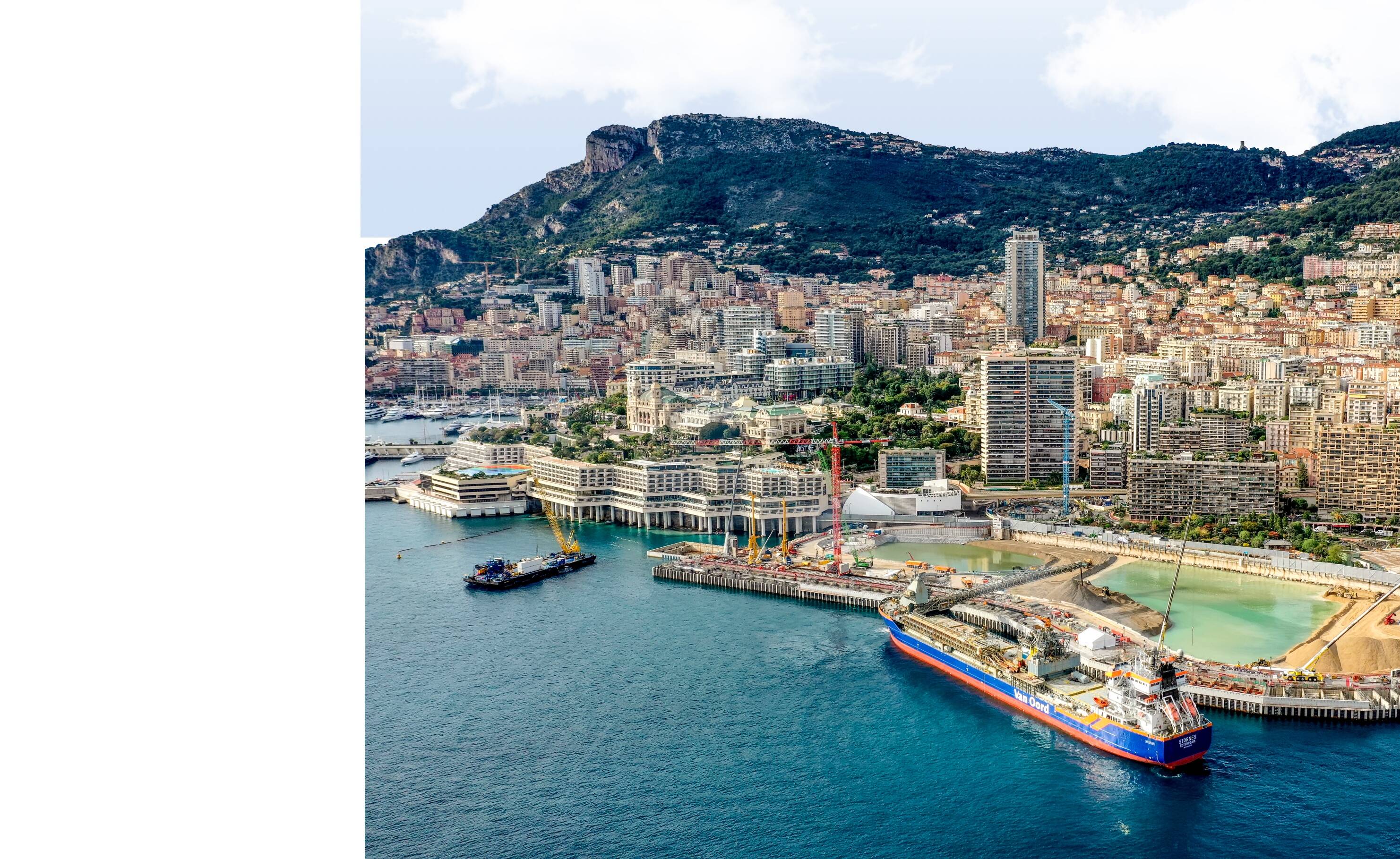 The coast of Monaco with a Van oord vessel docked at the harbour