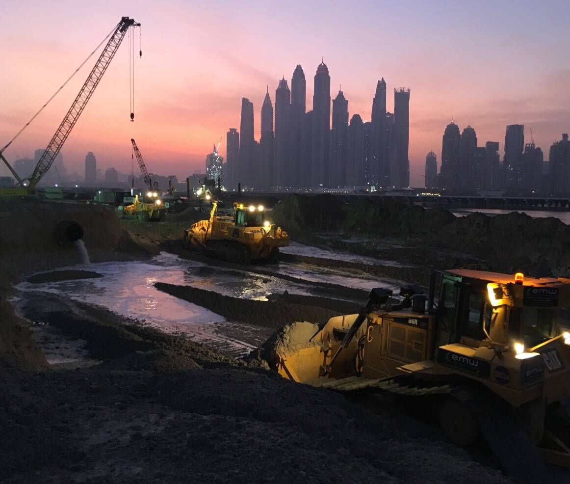 Working at the Dubai coastline in the night with heavy equipment